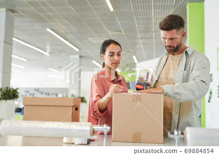 Couple Packing Boxes Together 69884854