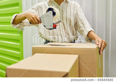 Woman Packing Boxes in Storage Unit Close Up 69884880