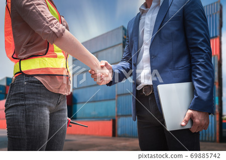 Businessman and Container Shipping Worker Handshake Together for Cooperation Shipment  69885742