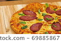 Appetizing hot pepperoni pizza lies on a tray. Appetizing hot pepperoni pizza lies on a tray. Close 69885867