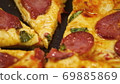 Human hands taking pieces slices of hot tasty italian pizza from open box, close up view 69885869