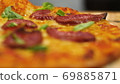 ppetizing hot pepperoni pizza lies on a tray. Close-up. Slow motion 69885871