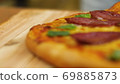 ppetizing hot pepperoni pizza lies on a tray. Close-up. Slow motion 69885873