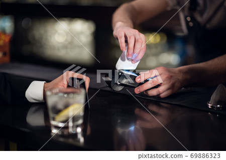 payment for an order in a bar using a non-cash payment method payment for an order in a bar using a non-cash payment method 69886323