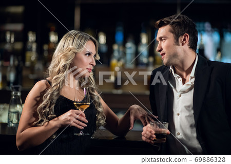a man meets a beautiful blonde at the bar a man meets a beautiful blonde at the bar 69886328
