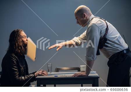 The investigator who lost his calm throws a folder with documents at the suspect The investigator who lost his calm throws a folder with documents at the suspect 69886636