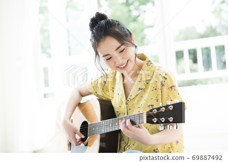 Female guitar smile 69887492