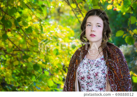 Sad women in a shawl in the park Sad women in a shawl in the park 69888012