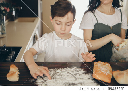 the family makes cakes. the children were covered in flour. dinner at the bakery. feast in the kitchen. mother's little helpers 69888361