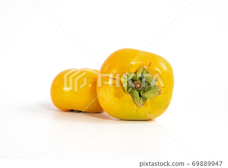 Fresh ripe persimmon fruit isolated on white background. Healthy food concept Fresh ripe persimmon fruit isolated on white background. Healthy food concept 69889947