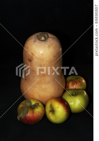 vertical art photo of pumpkin and ripe apples close-up on black background vertical art photo of pumpkin and ripe apples close-up on black background 69890807