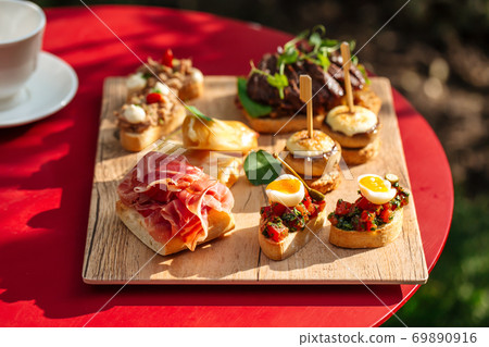 Assorted spanish tapas with different toppings Assorted spanish tapas with different toppings 69890916