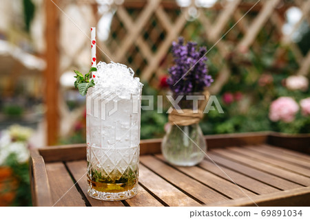 Fresh mojito cocktail with crushed ice on the tray Fresh mojito cocktail with crushed ice on the tray 69891034