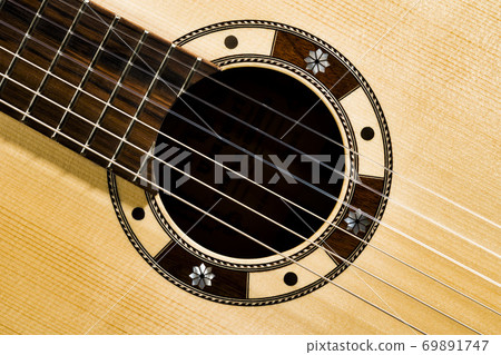 Closeup of rosette sound hole of an acoustic guitar Closeup of rosette sound hole of an acoustic guitar 69891747