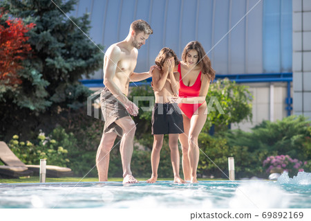 Boy with parents spending time by the pool Boy with parents spending time by the pool 69892169