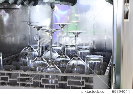 Open dishwasher with clean glass, cups, plates and dishes, selective focus Open dishwasher with clean glass, cups, plates and dishes, selective focus 69894044