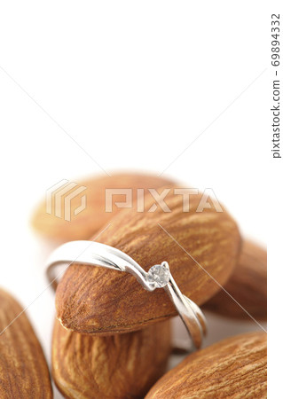 Photographed almonds and diamonds on a white background. Almonds. 69894332