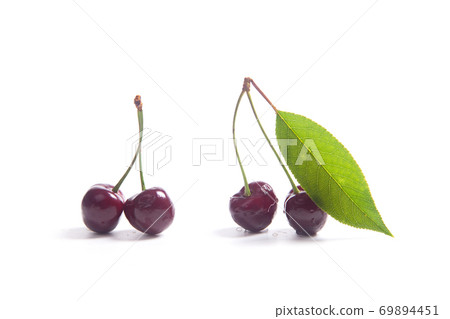 Red sweet cherry with green leaf isolate on white. Red sweet cherry with green leaf isolate on white. 69894451