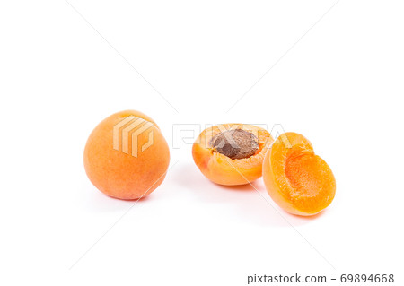 Several of harvested apricots whole and halved on white background.. Several of harvested apricots whole and halved on white background.. 69894668