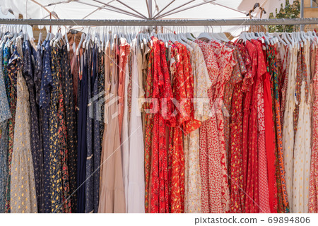 Dresses on coat rack on sale at street market in Aix-en-Provence, France 69894806