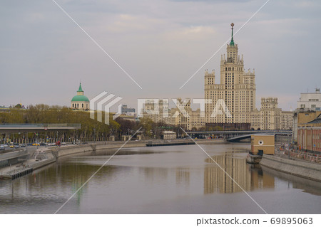 Photography of Stalinist skyscraper on Kotelnicheskaya embankment and Observation Deck Zaryadye Park in spring sunset. International touristic concepts during coronavirus pandemic time. No people. Photography of Stalinist skyscraper on Kotelnicheskaya embankment and Observation Deck Zaryadye Park in spring sunset. International touristic concepts during coronavirus pandemic time. No people. 69895063