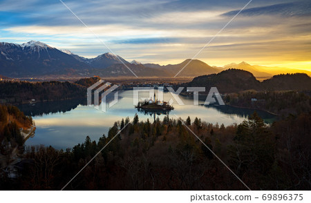 Aerial view of Lake Bled and Julian Alps, with Pilgrimage Church of the Assumption of Maria at sunrise, Slovenia 69896375