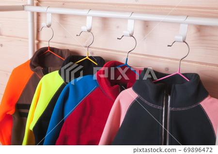 Colorful fleece jackets are on rack 69896472