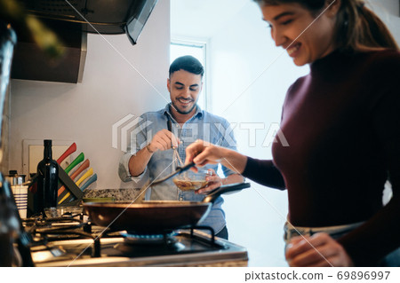 Husband And Wife Cooking Together An Omelette For Breakfast Husband And Wife Cooking Together An Omelette For Breakfast 69896997