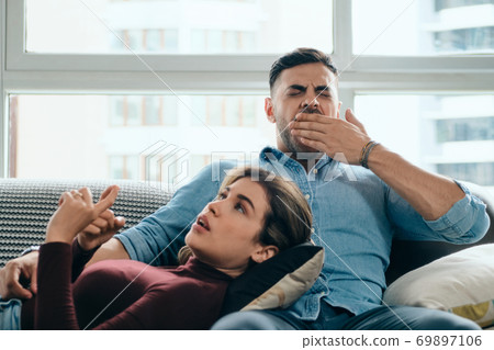 Man Yawning During Boring Conversation With Partner Man Yawning During Boring Conversation With Partner 69897106