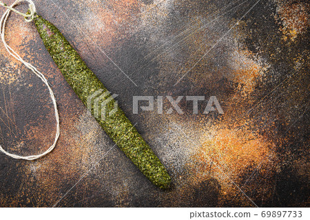 Spanish dry salami fuet in herbs on old metall background with space for text 69897733