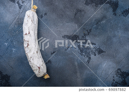 Whole spanish salchichon wurst on blue background, top view with copy space Whole spanish salchichon wurst on blue background, top view with copy space 69897882