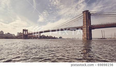 Retro toned picture of Brooklyn Bridge against the sun, New York. Retro toned picture of Brooklyn Bridge against the sun, New York. 69898156