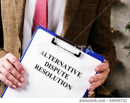 Lawyer offers documents alternative dispute resolution ADR and pen. Lawyer offers documents alternative dispute resolution ADR and pen. 69899732