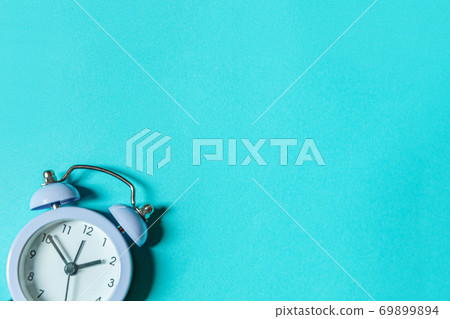 Simply minimal design ringing twin bell vintage classic alarm clock Isolated on blue pastel background. Rest hours time of life good morning night wake up awake concept. Flat lay top view, copy space Simply minimal design ringing twin bell vintage classic alarm clock Isolated on blue pastel background. Rest hours time of life good morning night wake up awake concept. Flat lay top view, copy space 69899894