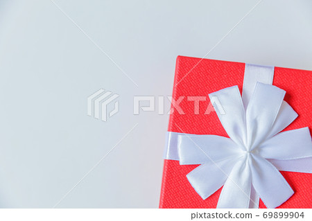 Christmas New Year birthday valentine celebration present romantic concept. Simply minimal design red gift box isolated on white background. Flat lay top view copy space. Christmas New Year birthday valentine celebration present romantic concept. Simply minimal design red gift box isolated on white background. Flat lay top view copy space. 69899904