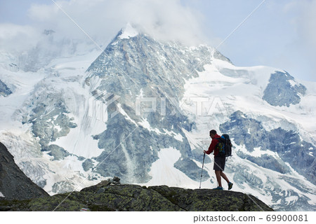 Tourist walking in mountains using trakking sticks. 69900081