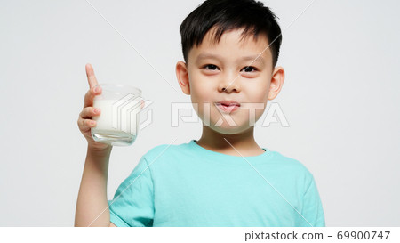 Cute boy with a glass of milk Cute boy with a glass of milk 69900747