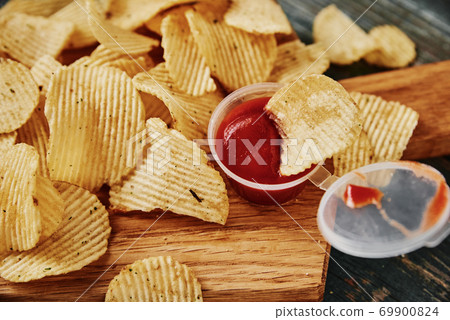 Potato chips and sauce on the table, close up Potato chips and sauce on the table, close up 69900824