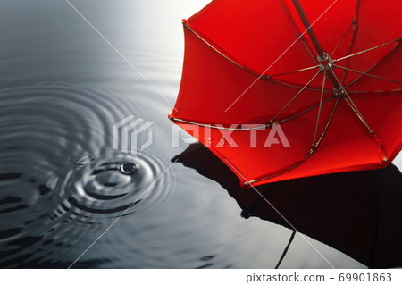 Umbrella on the rain. Umbrella inpuddle. Autumn background concept. 69901863