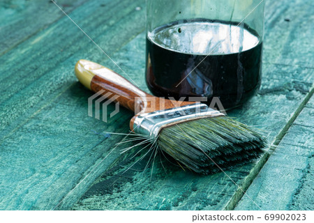Tool paintbrush and jar of paint housework background 69902023