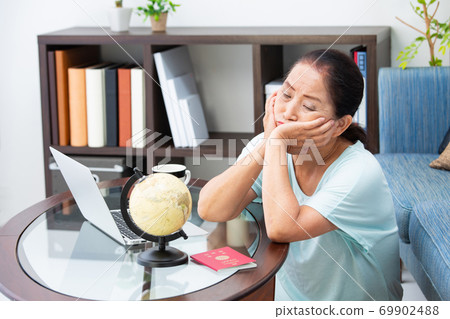 Senior woman worried about having a passport 69902488