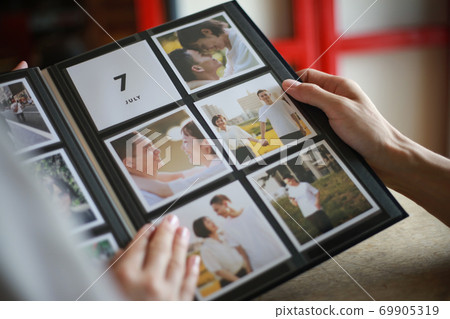 Couple watching the album Couple watching the album 69905319