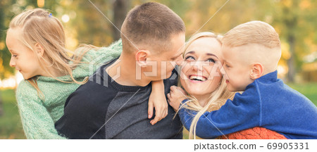 Portrait of young family in autumn park 69905331
