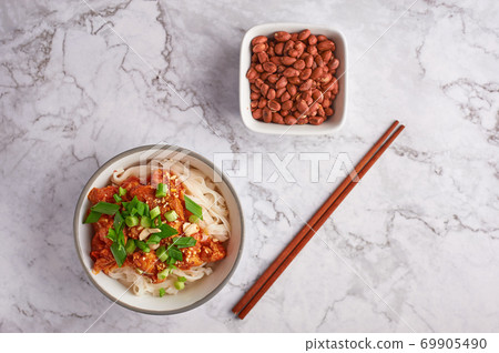 shan noodles with peanuts and chopsticks at white marble tabletop. burmese cuisine traditional dish shan noodles with peanuts and chopsticks at white marble tabletop. burmese cuisine traditional dish 69905490
