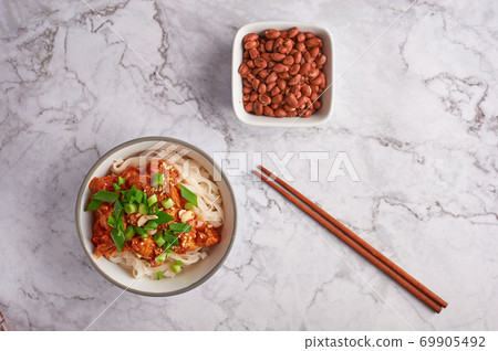 shan noodles with peanuts and chopsticks at white marble tabletop. burmese cuisine traditional dish shan noodles with peanuts and chopsticks at white marble tabletop. burmese cuisine traditional dish 69905492