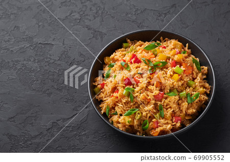 Veg Schezwan Fried Rice in black bowl at dark slate background. indo-chinese cuisine dish 69905552