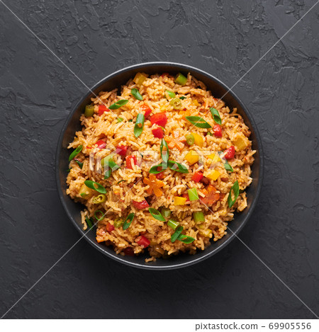 Veg Schezwan Fried Rice in black bowl at dark slate background. indo-chinese cuisine dish Veg Schezwan Fried Rice in black bowl at dark slate background. indo-chinese cuisine dish 69905556