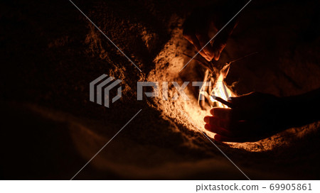 tourist makes a fire on the beach tourist makes a fire on the beach 69905861