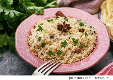 Jeera Rice in pink plate at dark bacgkround. Jeera Rice in pink plate at dark bacgkround. 69906030