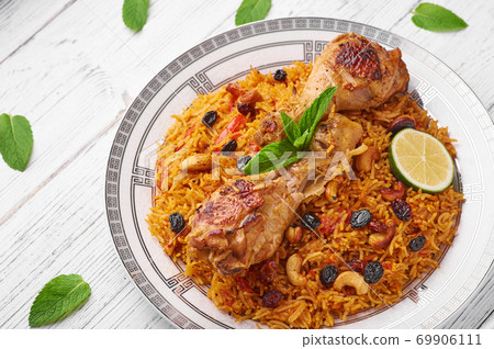 Kabsa at white wooden background. Kabsa is traditional saudi arabian cuisine dish. 69906111